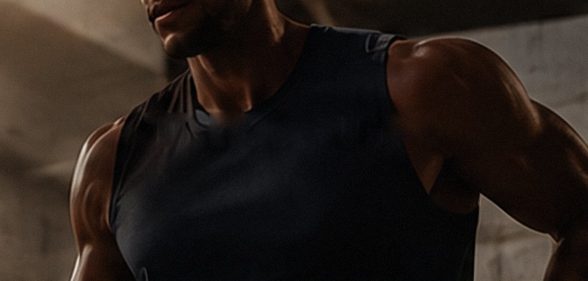 An athlete in a black FEINT training tank
